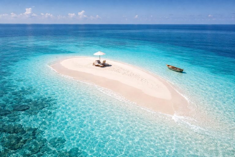 Aerial view of a secluded white-sand sandbar and turquoise ocean, one of the best beach holiday destinations in Asia 2026.